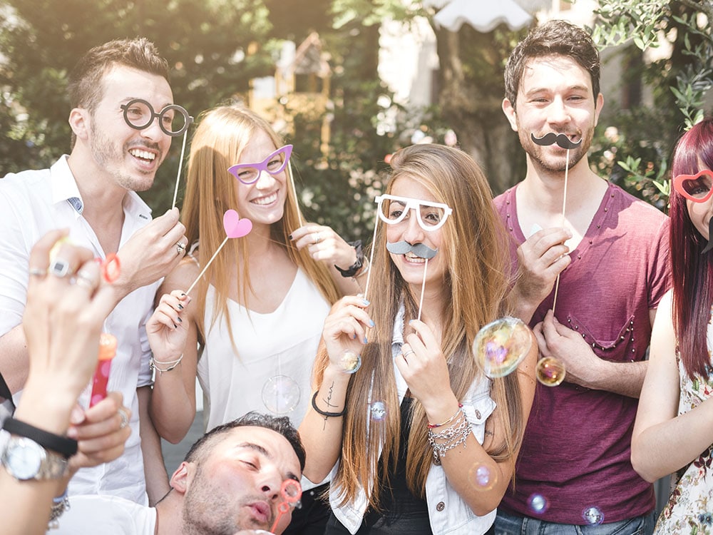 friends having fun with props during a photo booth