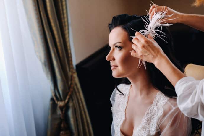 the bride is decorated with feathers in her hairstyle.morning of the bride