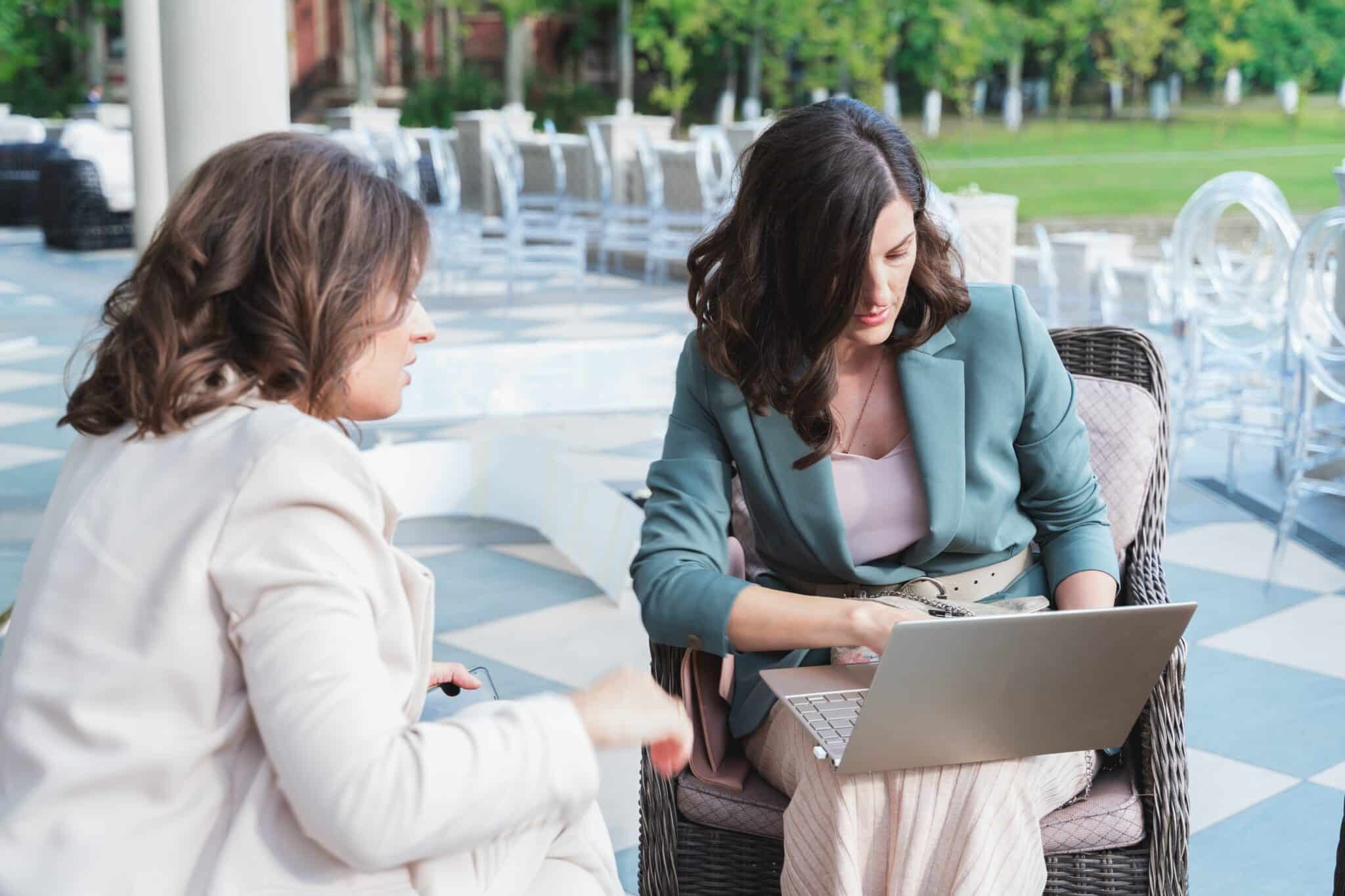 wedding planners, organizers, event decorators, managers with laptop.business meeting,negotiations,project discussion,signing contract with client,customer.women, girls in stylish suits in restaurant
